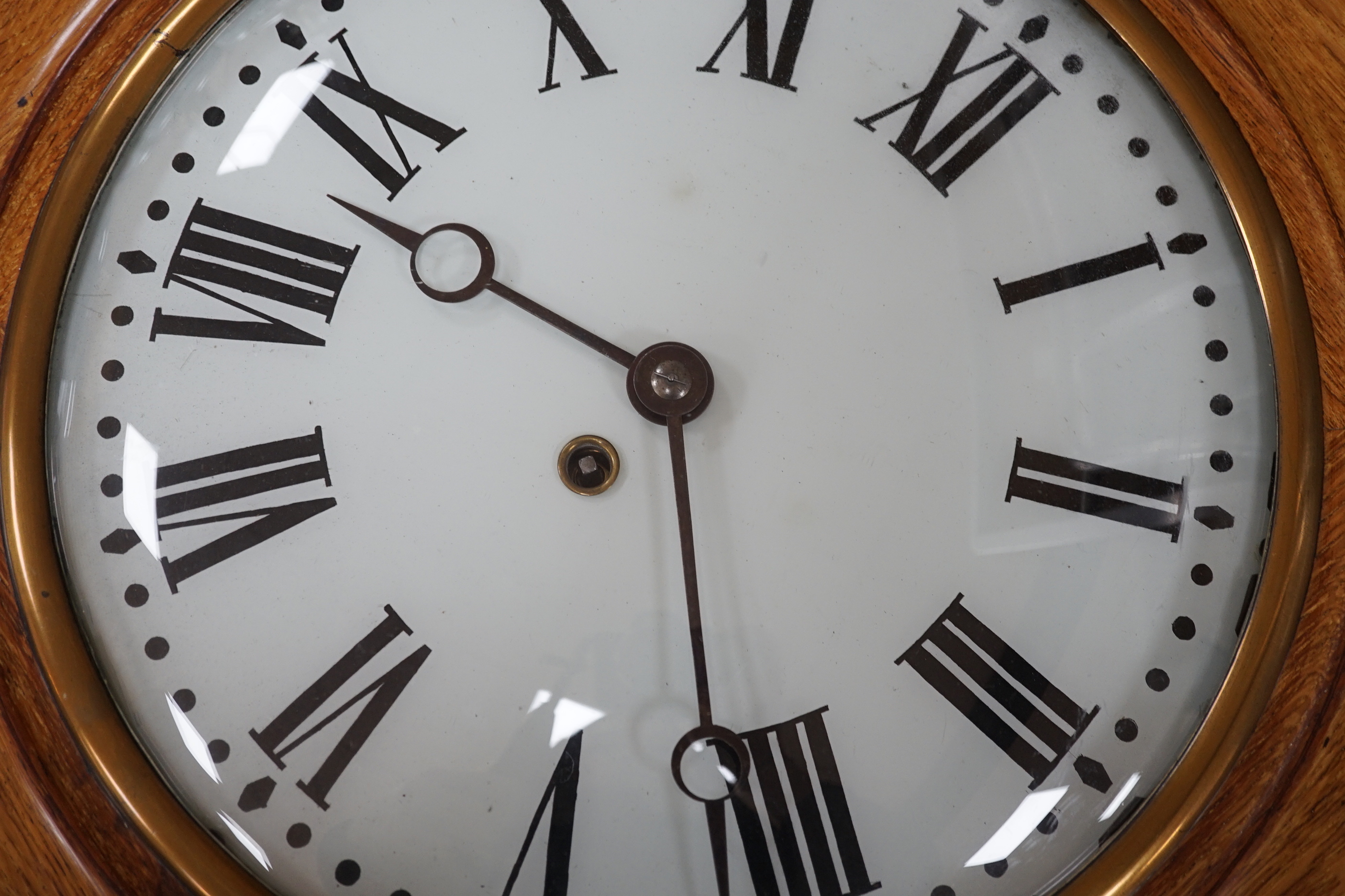 An early 20th century oak wall dial, 46cm diameter